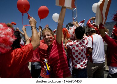 Sports Fans Cheering With Arms Raised