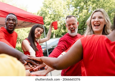 Sports Fans In A Huddle At A Tailgate Event