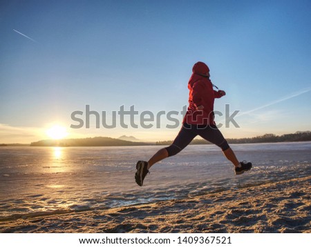 Sports and  Fitness. Fit person running at shore, workout jogging theme at  winter beach. 
