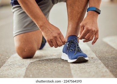 Sports, fitness or hands tie shoes to start training, cardio workout or exercise in city road. Legs, man or healthy athlete runner with running shoes or footwear laces ready for body goals or race