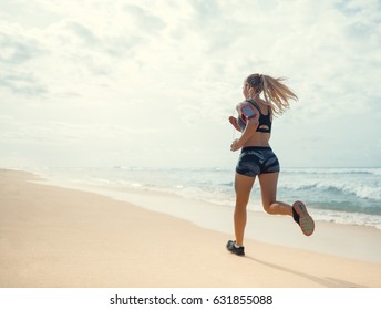 Sports Girl Running On The Beach