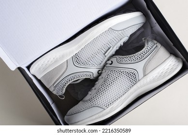 Sports Gray Summer Sneakers In A Box On A Light Background, Top View. Pair Of New Shoes, Close-up.