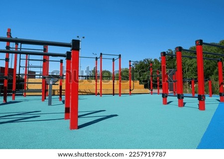 Sports ground with horizontal bars and other new exercise equipment in open air sport zone in the city. Sports ground for physical exercise on open air