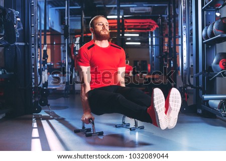 sports guy performs exercises in the gym