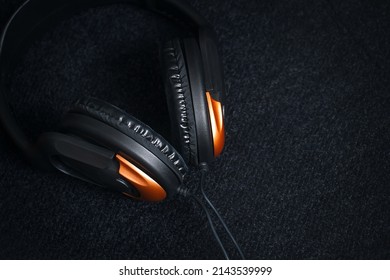 Sports headphones on a dark background, stock photo