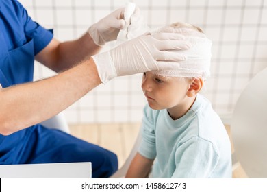 Sports Injury. Doctor Makes Bandage On Head Patient, In The Hospital.