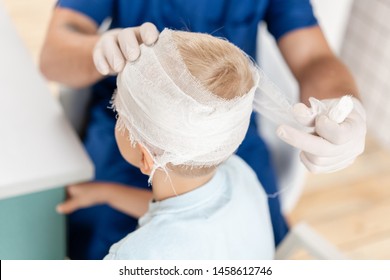 Sports Injury. Doctor Makes Bandage On Head Patient, In The Hospital.