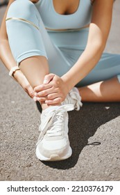 Sports, Injury And Fitness Ankle Pain During Exercise, Running And Training Outside With Muscle Or Joint. Woman, Risk And Hurt Hands Athlete Holding Broken Leg Bone With Bad Bruise In The Street