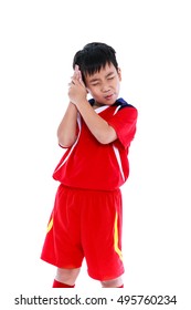 Sports Injury. Young Asian Soccer Player In Red Uniform Painful, His Hand On Head. Isolated On White Background. Negative Human Emotion, Facial Expression Feeling Reaction. Studio Shot.