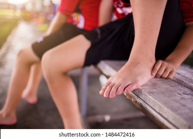 Sports Injury. Youth Soccer Player In Ankle Pain. Doctor Perform Checking And First Aid At Knee Trauma. Soccer Player Sitting Because Ankle Pain From Playing.