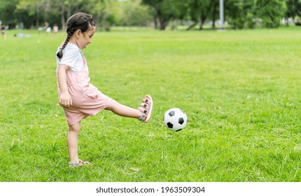 Sports Kid. Happy Little Girl Kid Kicking A Soccer Ball, Child Plays