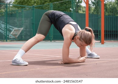 Sports and leisure. Caucasian sportive female boxer training at the stadium, warming up and stretching - Powered by Shutterstock