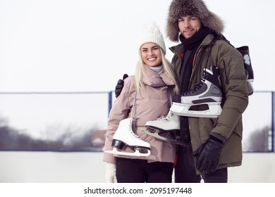 Sports and Lifestyle. Young Caucasian Couple On Skatingrink With Ice Skates Posing Together Over a Snowy Winter Landscape Outdoor. Horizontal image Composition - Shutterstock ID 2095197448