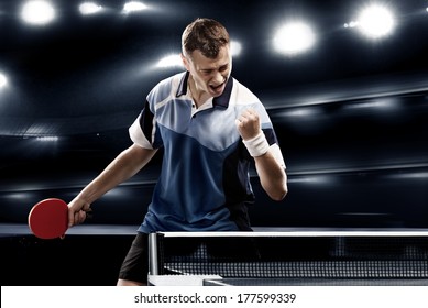 sports man celebrates victory on the dark background with lights - Powered by Shutterstock