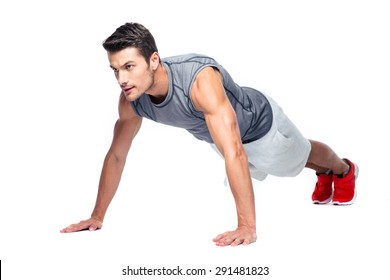 Sports man doing push ups isolated on a white background - Powered by Shutterstock