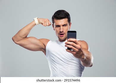 Sports Man Making Selfie Photo On Smartphone Over Gray Background