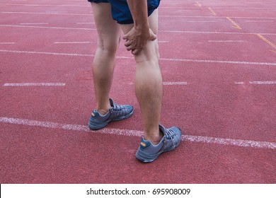 Sports Man Runner With Hamstring While Training In The Stadium