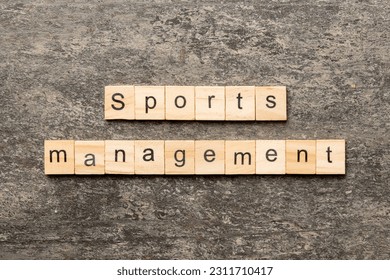 sports management word written on wood block. sports management text on cement table for your desing, concept. - Shutterstock ID 2311710417