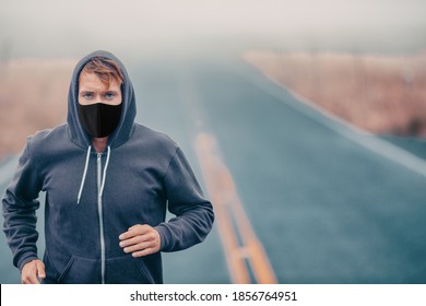 Sports Mask Endurance Athlete Runner Running Outside On Road Training While Wearing Facial Covering In Cold Weather Winter Fog. Male Jogger Man Jogging.