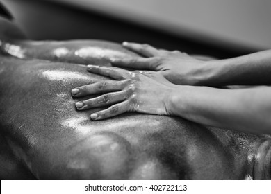 Sports Massage - Lower Back Massage - Physical Therapist Doing Massage Of Lower Back. Black And White Photo, Selective Focus.