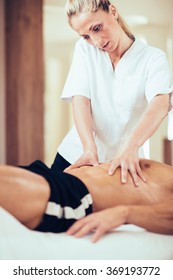 Sports Massage. Massage Therapist Massaging Stomach Of A Male Athlete. Toned Image