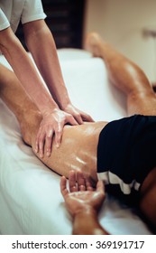 Sports Massage. Massage Therapist Massaging Thigh Of A Male Athlete. Toned Image