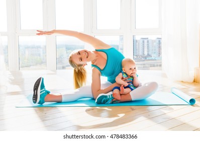sports mother is engaged in fitness and yoga with a baby at home 