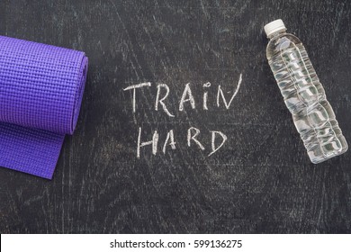 Sports motivational text. Train hard On a chalk board. - Powered by Shutterstock