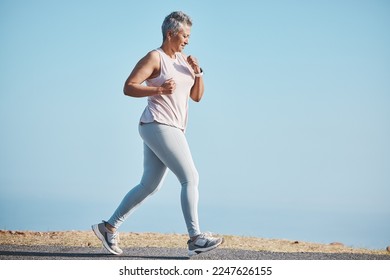 Sports, nature and senior woman doing a running workout for health, wellness and exercise in Puerto Rico. Fitness, runner and elderly female cardio athlete at outdoor training for a marathon or race. - Powered by Shutterstock