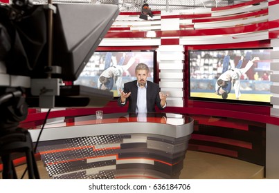 Sports News. A Television Anchorman At Studio During Live Broadcasting