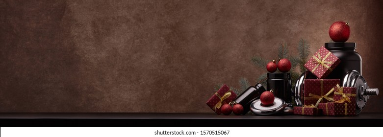 Sports Nutrition, Sports Equipment, Fir Branch,  Gifts, Christmas Ornaments On Dark Brown Background With Copy Space. Fitness, Sport, Healthy Lifestyle Concept. New Year. Christmas. Banner Background