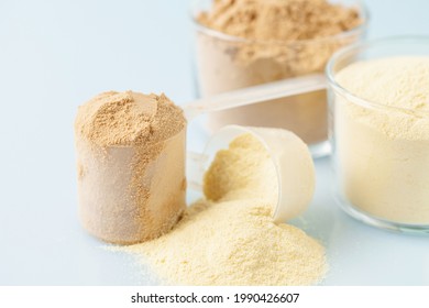 Sports Nutrition, Fitness Diet And Food Concept - Whey And Soy Protein Shake   Powder  On Blue Background