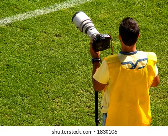 A Sports Photographer Working At A Soccer Game