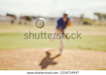 Sports, pitch and baseball ball in air, pitcher throwing it in match, game or practice in outdoor field. Fitness, exercise and training on baseball field with player in action, movement and motion