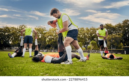 Sports, rugby and outdoor stretching legs on a grass field with a team doing warm up. Athlete men group together for fitness, exercise and workout for professional sport with coach and teamwork - Powered by Shutterstock