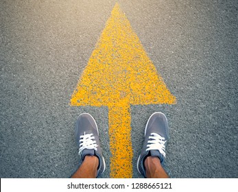 Sports shoes on road with yellow arrow line and vintage tone. soft focus
 - Shutterstock ID 1288665121