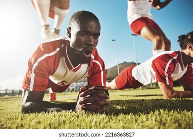 Sports, soccer and football team doing push up before game, match or tournament for health, fitness and exercise for warm up. Black men, workout and training group on outdoor field for sport practice - Powered by Shutterstock