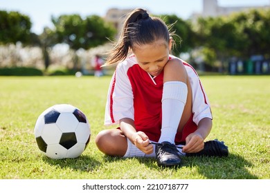 Sports, Soccer And Tie Shoes With Girl On Grass For Fitness, Games And Training In Brazil Event. Motivation, Workout And Exercise With Young Child On Football Field For Youth, Health And Wellness