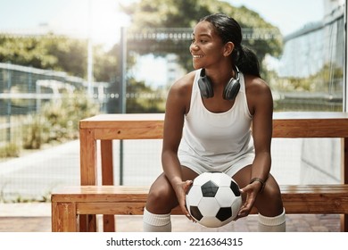 Sports, Soccer And A Woman On Bench With Ball In City Park In Sao Paulo. Fitness, Fun And A Happy Black Woman In Brazil Sitting, Holding Soccer Ball And Watching A Game In Summer Sun With Headphones