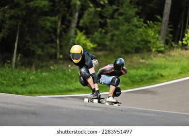 Sports, speed and safety, longboard skating in road, friends racing downhill with skateboard and helmet. Extreme sport adventure, skateboarding street race and skateboarder riding on mountain pass