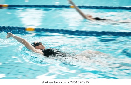 Sports, swimmer or people training in swimming pool for a race competition, exercise or cardio workout. Women, backstroke or athletes with energy or speed in fitness practice challenge for wellness - Powered by Shutterstock