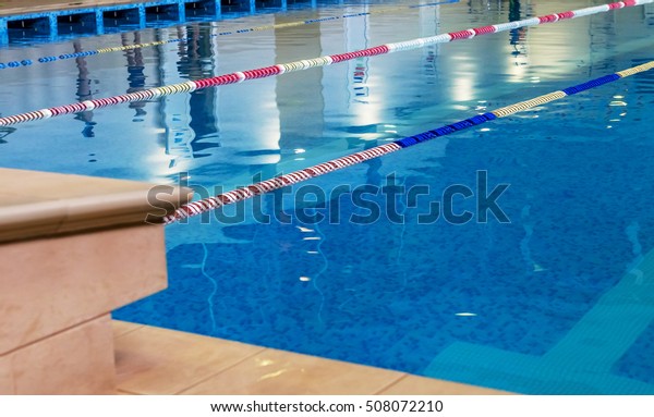 Sports\
Swimming Pool. Interior bath sports pool, divided swimming lanes\
for swimmers, tables to start during\
competitions
