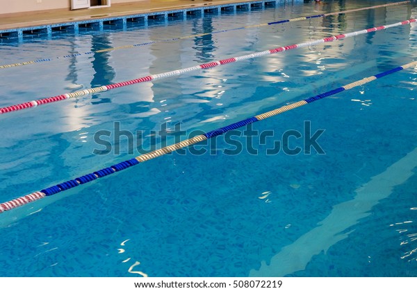 Sports\
Swimming Pool. Interior bath sports pool, divided swimming lanes\
for swimmers, tables to start during\
competitions