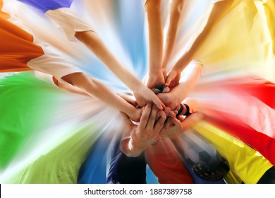 Sports Team All Hands Together. Happy Teammates Standing Together in Circle With All Hands  on Deck. Teamwork in Sports Team. Group of Young Players in Colourful Shirts Showing Team Power