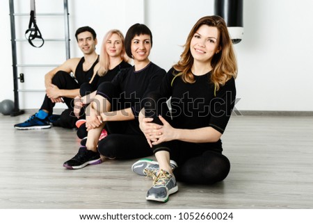 Similar – Close up front portrait of three young and middle age athletic women in sportswear in gym over dark background, looking at camera