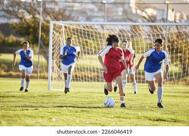 Sports team, girl soccer and kick ball on field in a tournament. Football, competition and athletic female teen group play game on grass. Fit adolescents compete to win match at school championship. - Shutterstock ID 2266046419