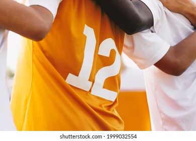  Sports Team Members United. Closeup Image Of Soccer Shirt Back Side. Footballers Standing Together In A Row Huddling. Team Spirit In A Sports Team