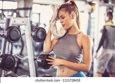 Sports Tired Woman After Exercise Wipes Sweat. Focus Is On Woman.