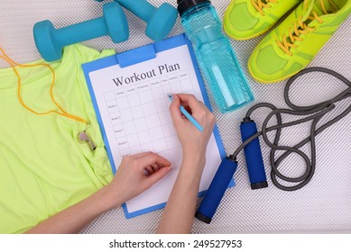 Sports Trainer Amounts To Workout Plan Close-up 