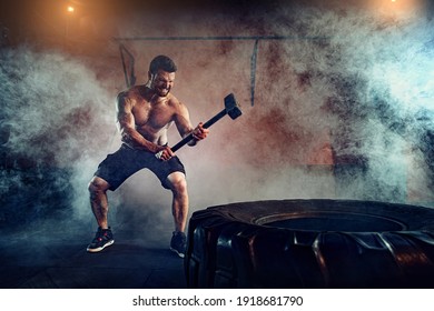 Sports training for endurance, man hits hammer. Concept workout. - Powered by Shutterstock